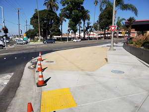 Image shows new sidewalk and curb ramp at south east corner of PCH and Aviation intersection